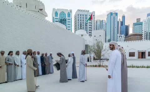 Emirati Middle Eastern Men performing the Yowla, a traditional dance Foto stock