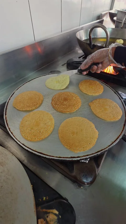 Emirati mini pancakes, Chebab being prepared at a sweet shop in Abu Dhabi Stock Footage 333979905