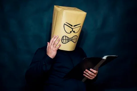 Emotion concept. A man is reading notes in a notebook. The expression on his Stock Photos