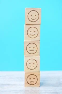 Emotion face blocks on blue background. Service rating, ranking, customer rev Stock Photos