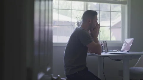 Emotional 30-Something Types on Laptop Computer at  Desk In Window Light Stock Footage 208766016