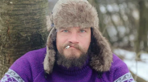 Emotional bearded man looking into the camera, swearing, smoking, laughing. Stock-Footage 59659963