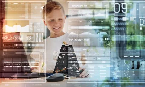 Emotional cheerful boy smiling while admiring a new robot Foto stock