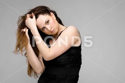 Emotional confident plus size model standing in studio showing her sexuality on Stock Photos