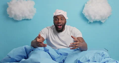 Emotional dark skinned man gestures actively makes yes gesture watches Stock Footage 148994029