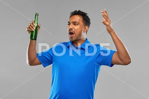 Emotional indian man or sports fan beer bottle Stock Photos