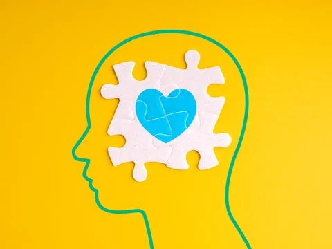 Emotional intelligence concept with human head silhouette and puzzle heart .. Stock Photos