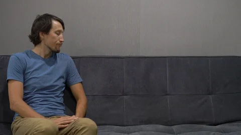 Emotional intelligence concept. A man disappointed by what is happening on the Stock Footage 102882804