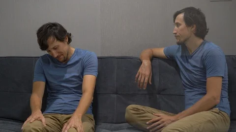 Emotional intelligence concept. On one side of a young man feeling upset and Stock Footage 102877053