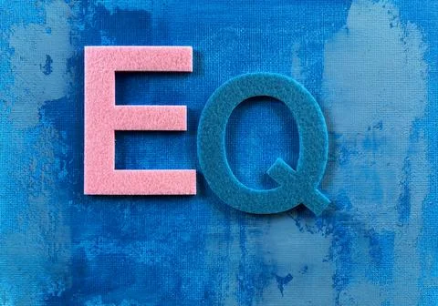 Emotional Intelligence EQ Letters on Abstract Blue Canvas Background Stock Photos