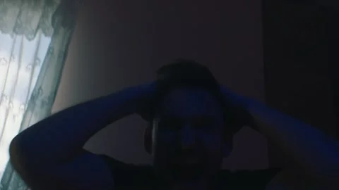 Emotional man behaving inappropriately while sitting at home Stock Footage 131398358