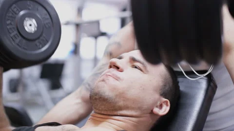 Emotional man does flat dumbell press and cry Stock Footage 63390696