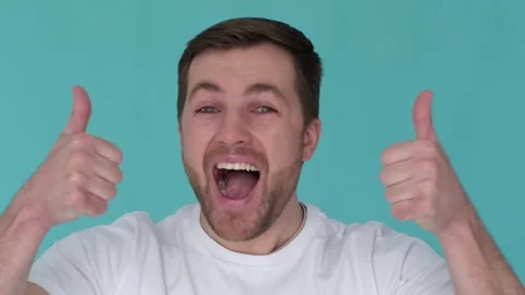 Emotional man looking at camera in slow motion. Handsome guy with a wow Stock Footage 250172321