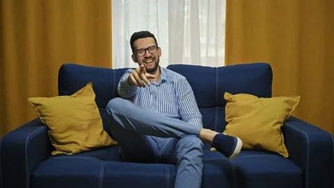 Emotional man points at camera expresses astonishment follows something stares Stock Footage 156957100