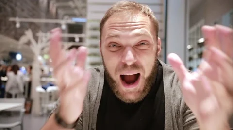 Emotional man screaming in camera. Man emotionally saying something. Angry Stock Footage 67948053