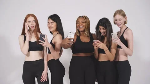 Emotional mixed race models using mobile phone posing at camera. Stock Footage 146363694