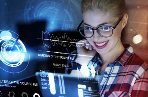 Emotional programmer smiling and looking at the screen Stock-Fotos