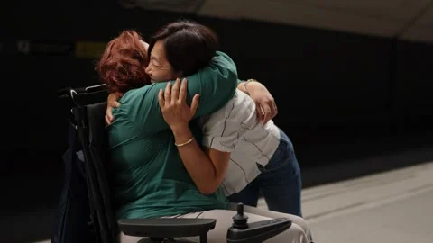 Emotional reunion hugging between two smiling women at train station Stock Footage 294702839
