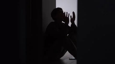 Emotional self talk after relationship conflict, lonely man silhouette sitting Stock Footage 325181981