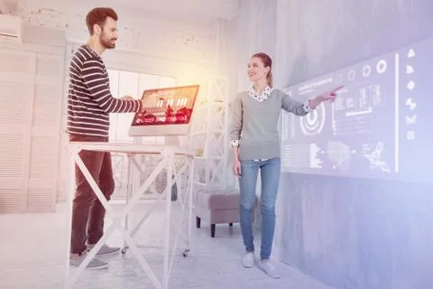 Emotional software developers smiling while working together Stock Photos