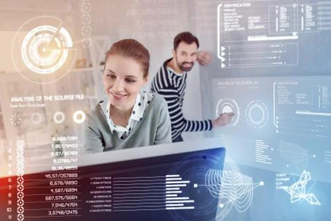 Emotional software developers smiling while working together Stock Photos