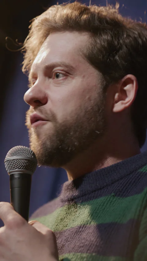 Emotional Stand Up Comedian Talking into Microphone during Stage Performance Stock Footage 333228406