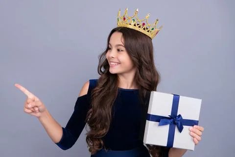 Emotional teenager child hold gift on birthday. Funny kid girl holding gift Stock Photos