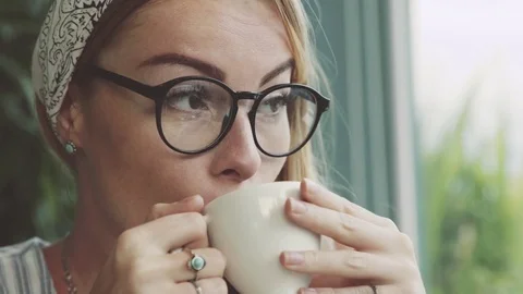 Emotional woman drinking coffee in cafe. Female student joking and laughing. Stock Footage