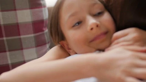Emotions. A happy child is hugging mom. The girl smiles and runs to Mom. Stock Footage