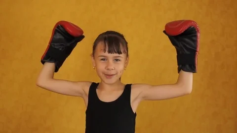Emotions of a little girl in boxing gloves. Stock Footage