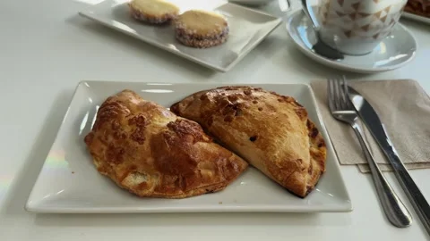 Empanadas on the table with coffee and dessert Alfajores. Stock Footage 296875231