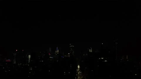 Empire State Building lighting up with July 4th fireworks show night NYC Stock Footage 134452889
