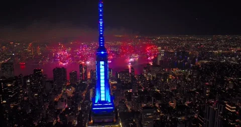 Empire State Building Lit Red White Blue o 4th of July with Fireworks Display Stock Footage 245367249