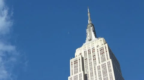 Empire State Building in New York City With Clouds and Flag Stock Video Stock Footage