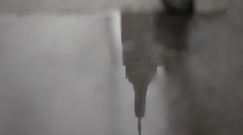 Empire State Building reflected in rain puddle, New York City, New York, USA Stock Footage