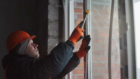 Employee aligns the plastic frames on the windows Stock Footage 82295965