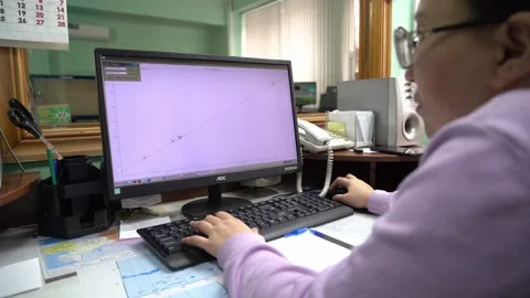 The employee analyzes the seismic activity data in the region Stock Footage 305696494
