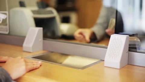 Employee and client count US dollar money on a counter at the currency exch.. Stock Footage 266475168