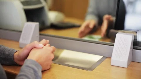 Employee and client count US dollar money on a counter at the currency exch.. Stock Footage 266475311