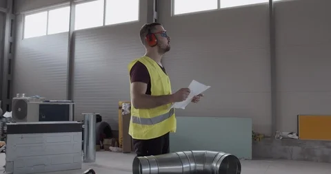 An employee, architect, checks the planning of the work done. Stock Footage 127204645