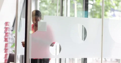 Employee arriving at office using her smartphone Stock Footage 79152592