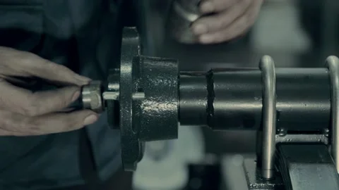 Employee assembles wheel hub installing metal parts in shop Video stock 133736172