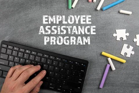 Employee Assistance Program. Computer keyboard and chalk pieces on a chalk board Stock Photos