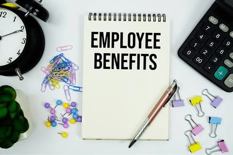 Employee Benefits text written on notepad with calculator and alarm clock Stock Photos