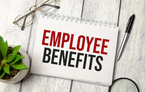 Employee Benefits words on notepad and pen, calculator and glasses Stock Photos