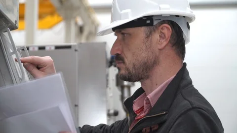 Employee carefully performs the settings of the equipment on the touch screen Stock-Footage 128935033