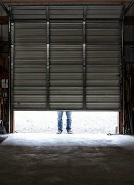Employee coming to work walking in a loading dock doorway. Stock Photos