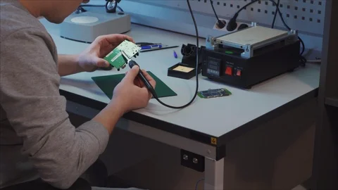 The employee completes work on a new module for robotics. Robotics Laboratory. 스톡 동영상 105972131