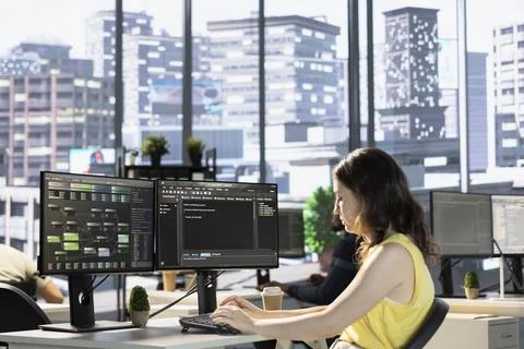 Employee conducting code review to fix bugs in machine learning company software Foto stock