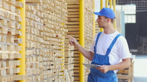Employee of construction shop writes figures with a marker on wood Stock Footage 57096795